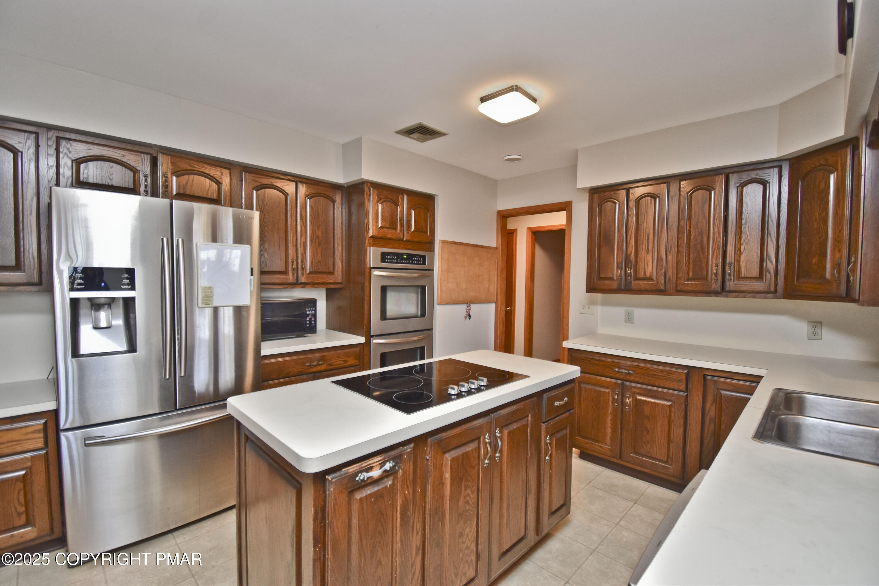 5294 Cherry Valley Road Saylorsburg, PA 18353 - Photo 6 of 53 a kitchen with stainless steel appliances granite countertop a refrigerator a sink and a stove