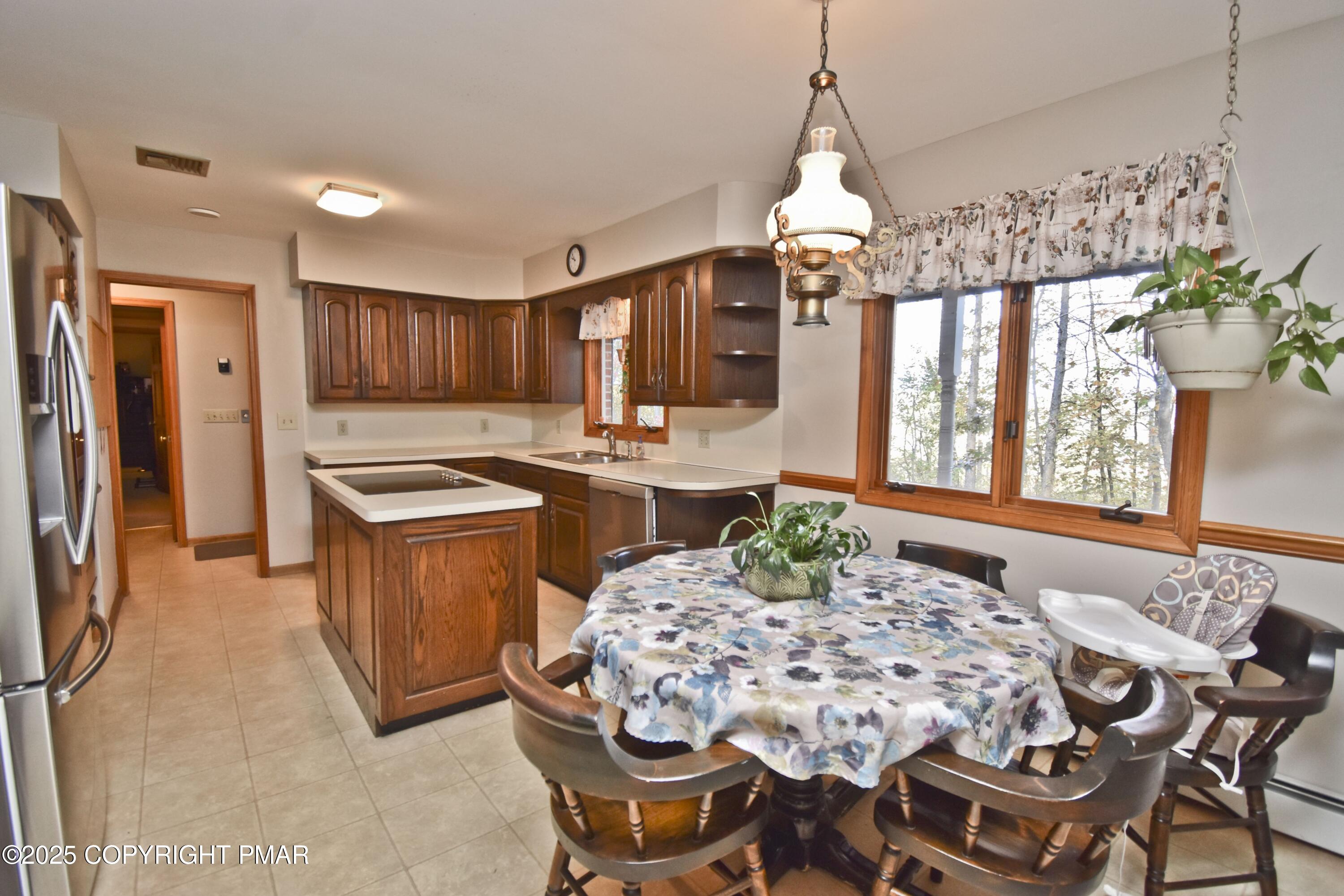 5294 Cherry Valley Road Saylorsburg, PA 18353 - Photo 8 of 53 a dining room with furniture a chandelier and window