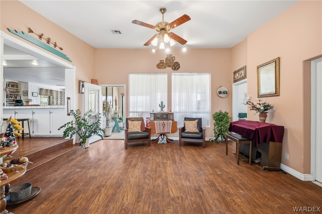 2401 North Stephan Road Kingman, AZ 86401 - Photo 24 of 92 a living room with furniture dining table and a large window with wooden floor