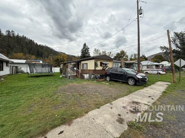 204 Front Street Kooskia, ID 83539 - Photo 22 of 25 View of front of property featuring a trampoline and a front lawn