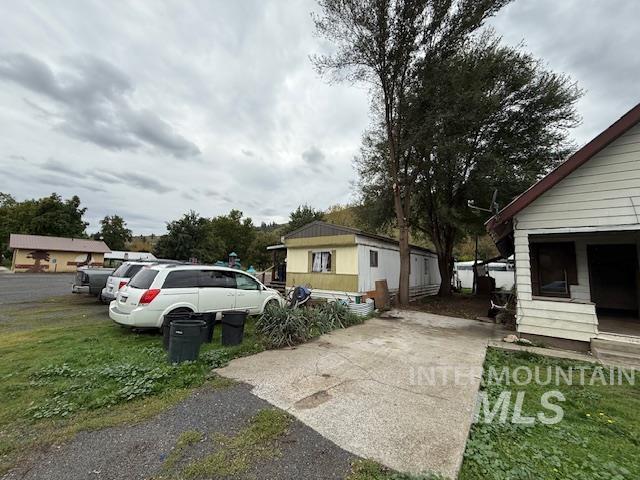 204 Front Street Kooskia, ID 83539 - Photo 4 of 25 View of side of property with driveway and a lawn
