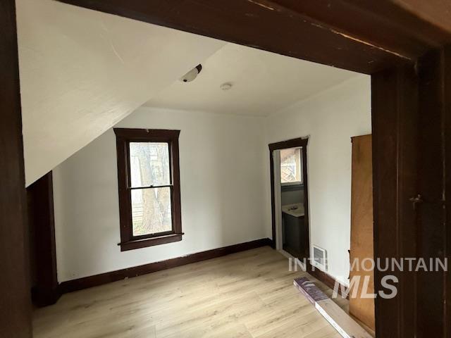 204 Front Street Kooskia, ID 83539 - Photo 10 of 25 Additional living space featuring healthy amount of natural light, light wood-style floors, and vaulted ceiling