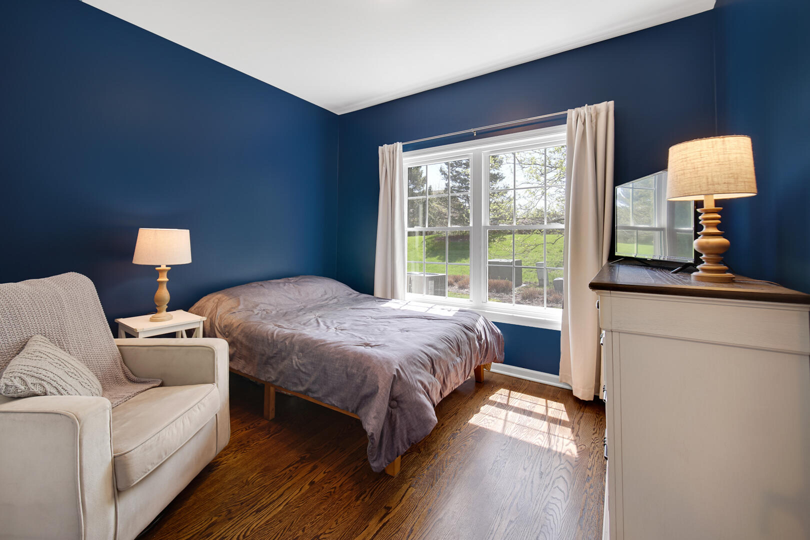 902 Boxwood Drive Munster, IN 46321 - Photo 14 of 23 a bedroom with a bed and a lamp