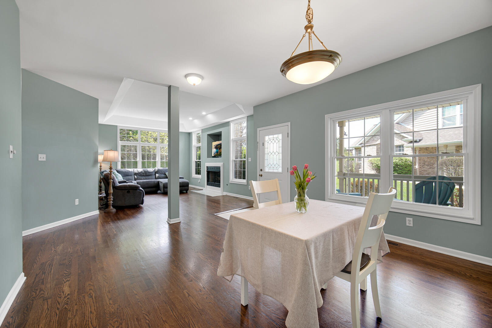 902 Boxwood Drive Munster, IN 46321 - Photo 7 of 23 a view of a dining room and livingroom with furniture wooden floor a chandelier