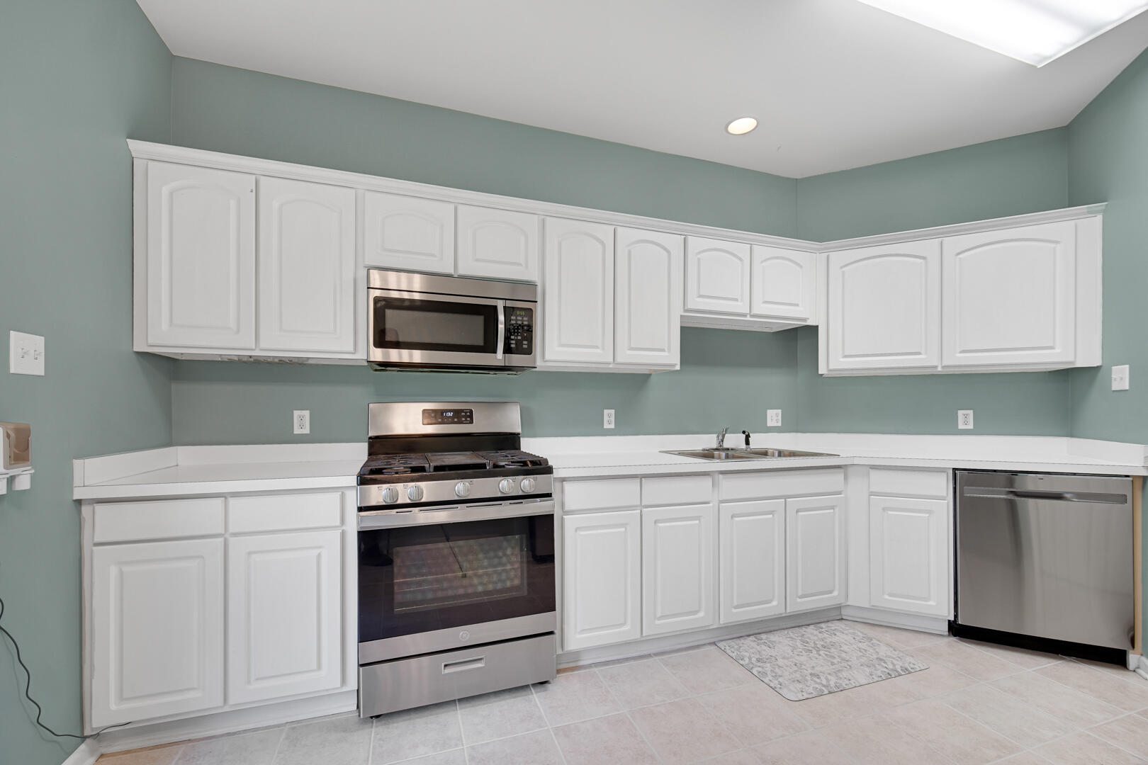 902 Boxwood Drive Munster, IN 46321 - Photo 9 of 23 a kitchen with white cabinets stainless steel appliances and sink