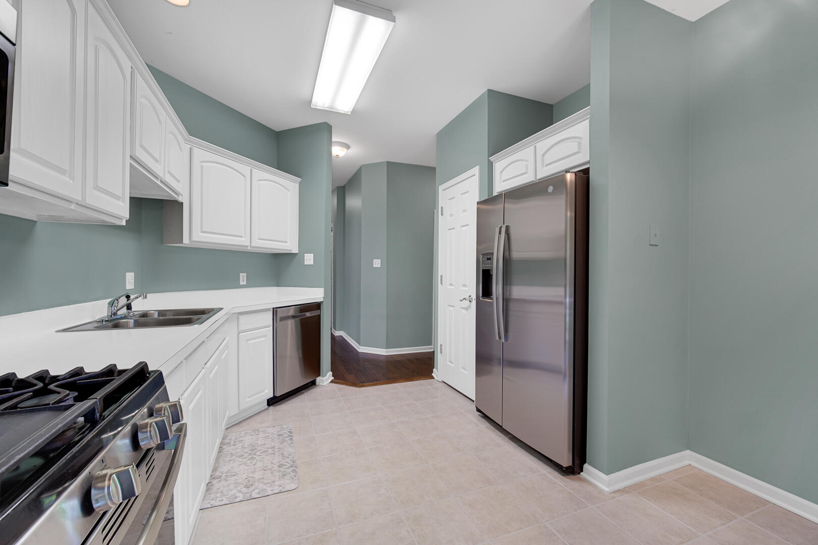902 Boxwood Drive Munster, IN 46321 - Photo 10 of 23 a kitchen with a refrigerator sink and cabinets