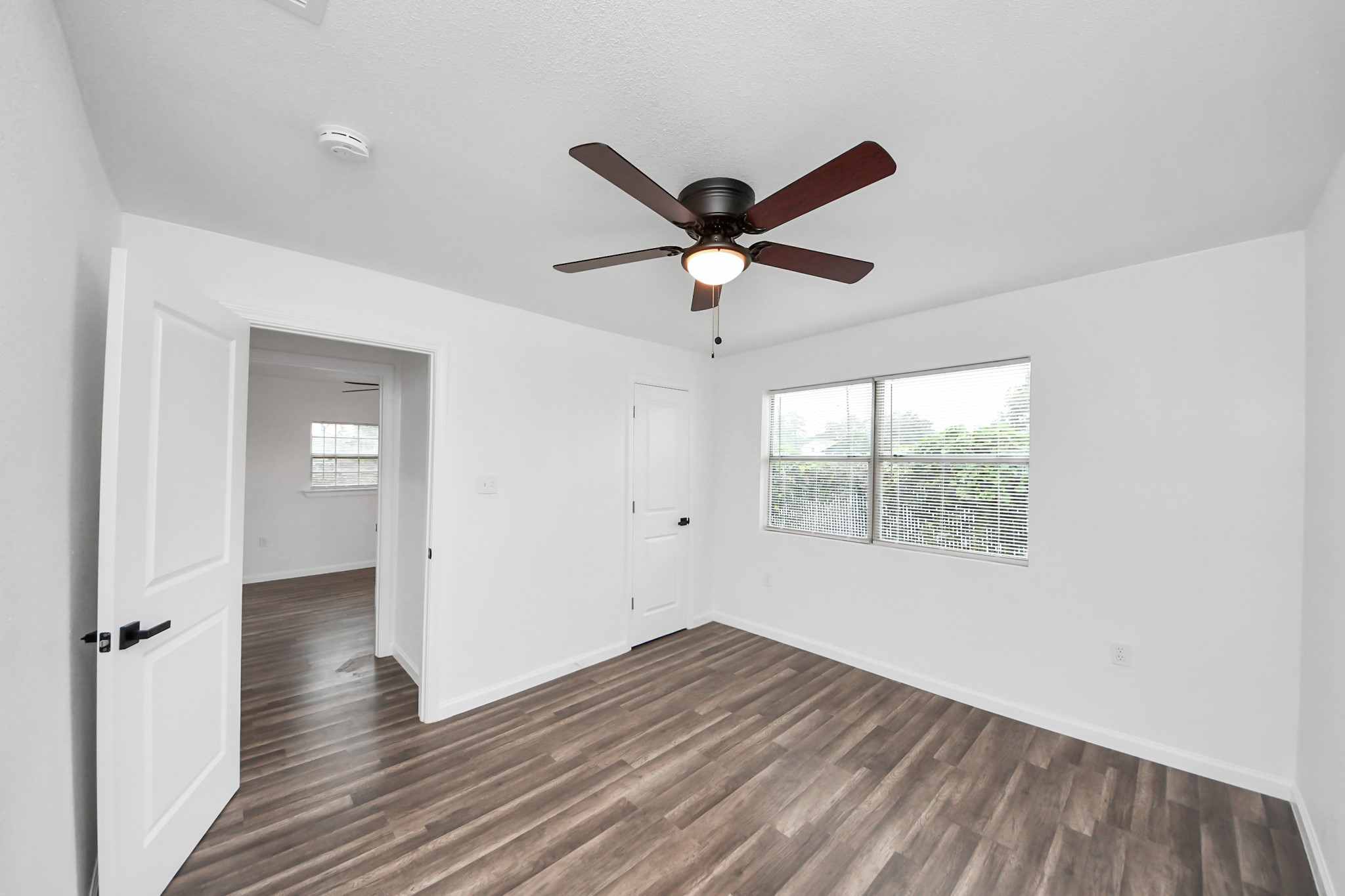207 East Defee Avenue Baytown, TX 77520 - Photo 29 of 36 a view of an empty room with wooden floor and a window