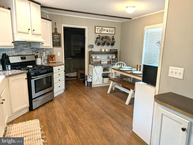 a kitchen with a stove a sink and a refrigerator