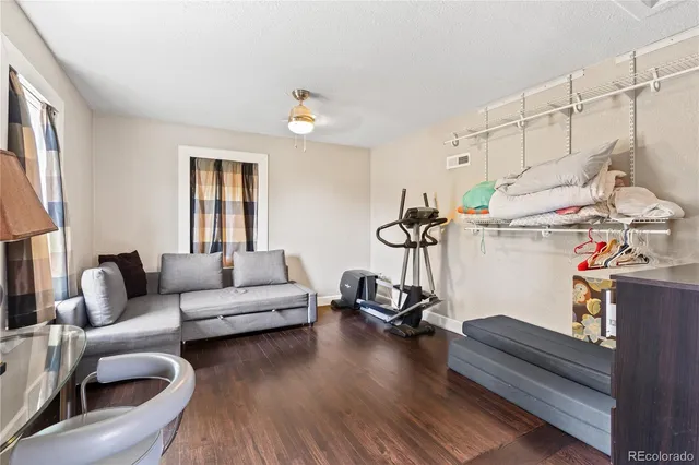 a living room with furniture a window and gym equipment