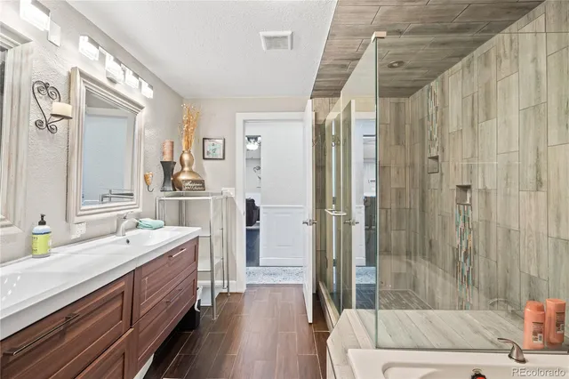 a spacious bathroom with double vanity and a bathtub