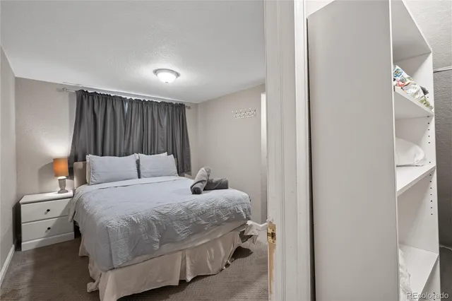 a bedroom with a bed and a night stand