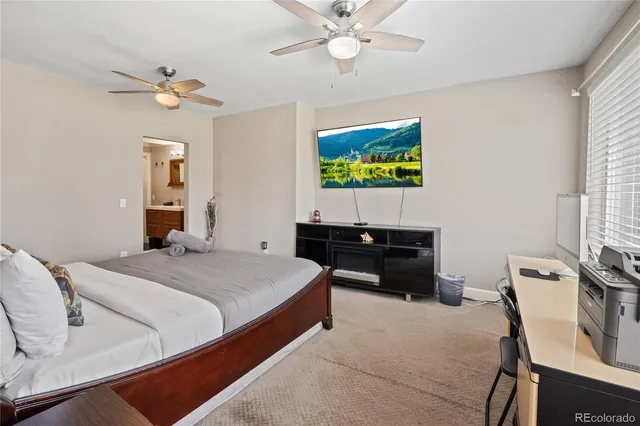 a bedroom with bed and a chandelier