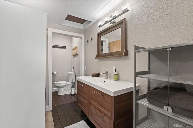 a bathroom with a sink toilet and mirror
