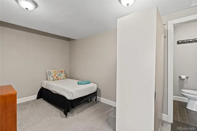 a room with a bed and wooden floor