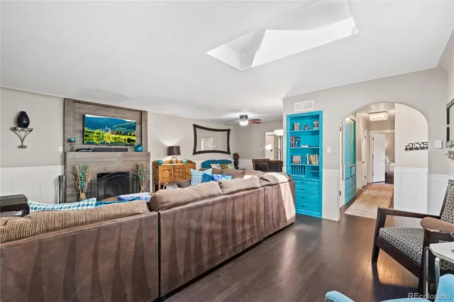 a living room with fireplace furniture and a window