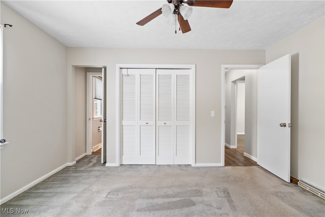 6059 Branch Road Medina, OH 44256 - Photo 18 of 39 Unfurnished bedroom with baseboards, a ceiling fan, light colored carpet, a textured ceiling, and a closet