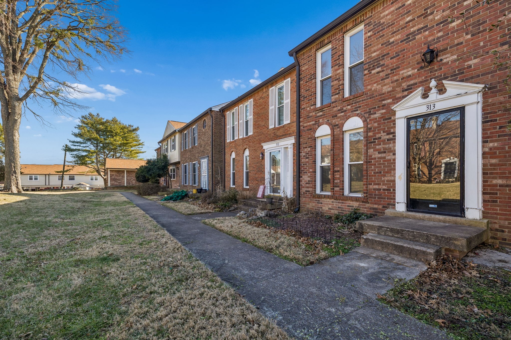 a view of a brick building next to a yard