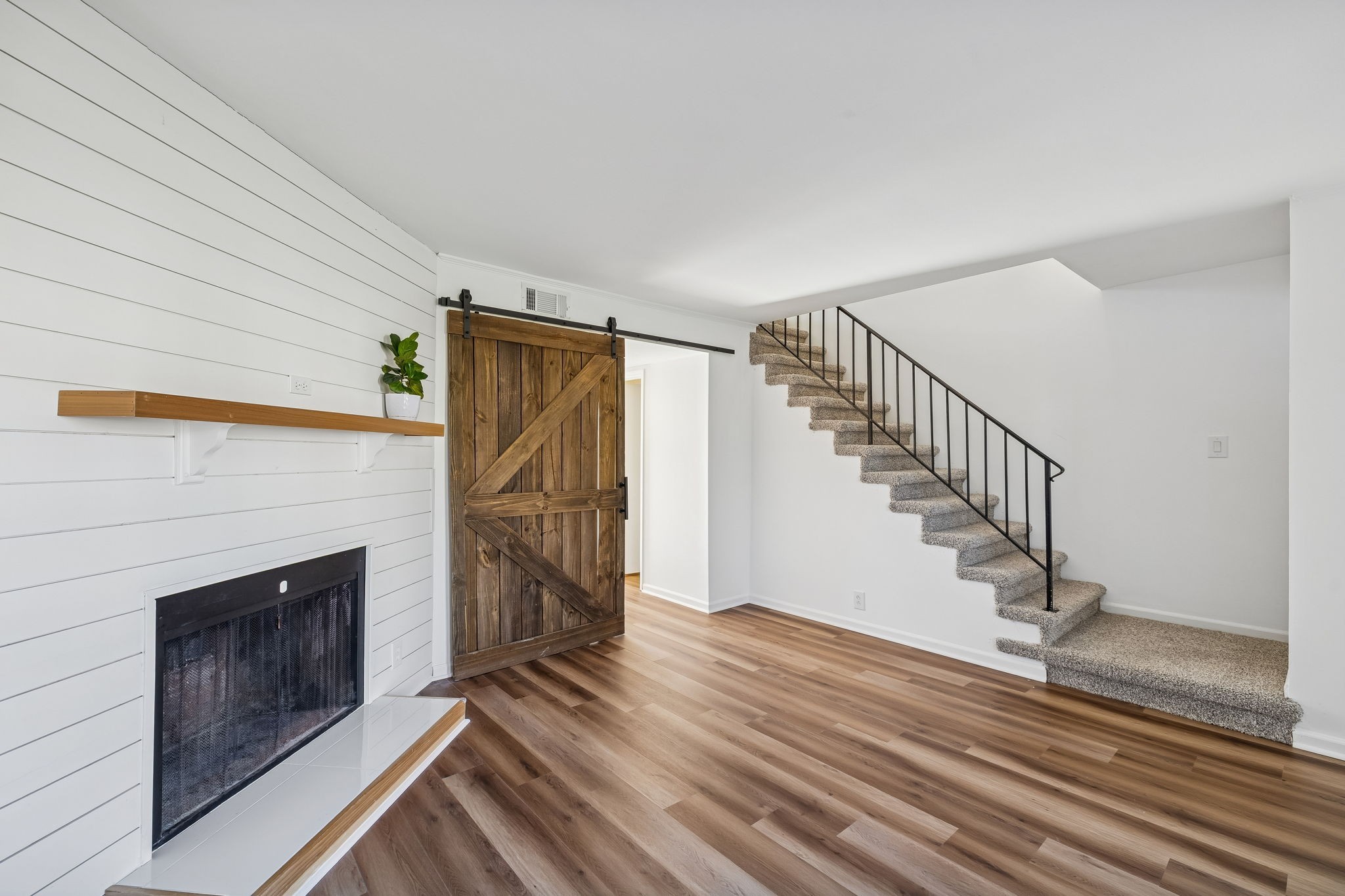 313 Huntington Ridge Drive Nashville, TN 37211 - Photo 8 of 48 a view of a livingroom with wooden floor staircase and a fireplace