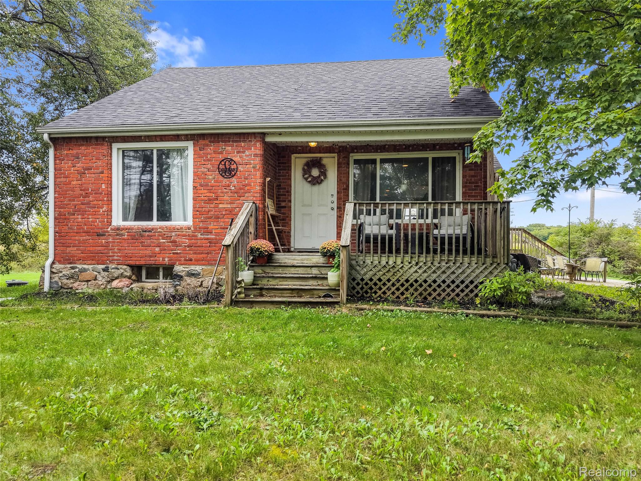 8330 Baldwin Road Gaines, MI 48436 - Photo 1 of 27 Red brick exterior with a gray shingle roof