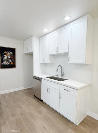 a kitchen with a sink cabinets and a window