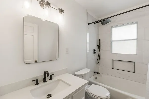a bathroom with a sink toilet and shower
