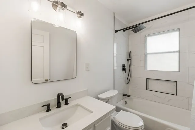 a bathroom with a sink toilet and shower