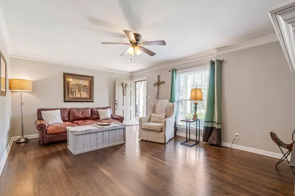 a living room with furniture and a wooden floor