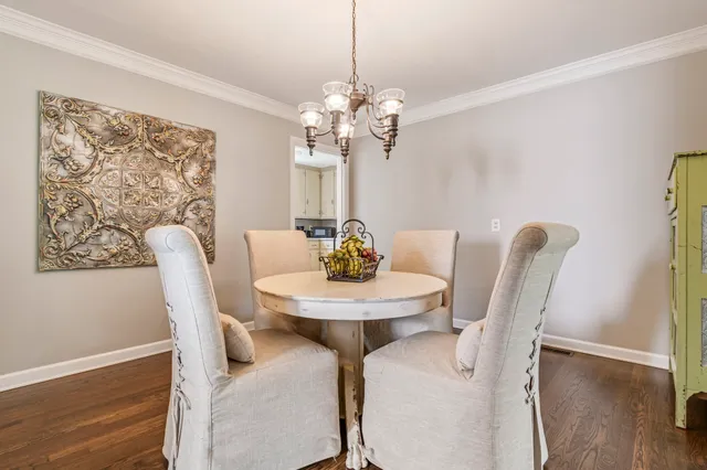 a dining room with furniture and chandelier