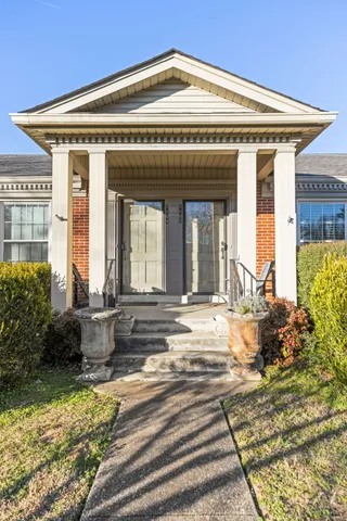 a view of a house with potted plants