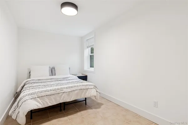 a bedroom with a bed and a lamp