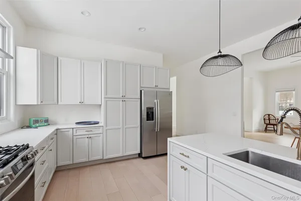 a kitchen with a sink cabinets and stainless steel appliances