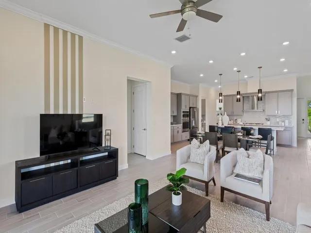 a kitchen with stainless steel appliances a sink stove refrigerator and cabinets