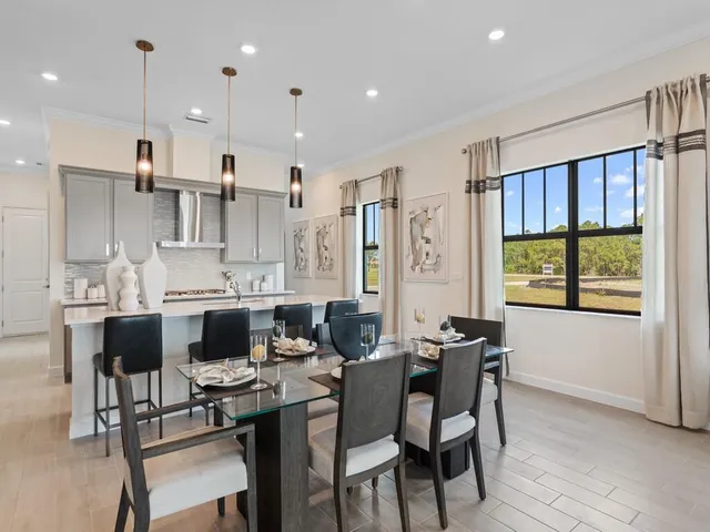 a view of a dining room with furniture and a floor to ceiling window