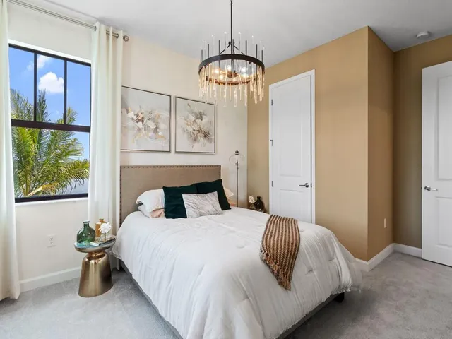 a bedroom with a bed and window