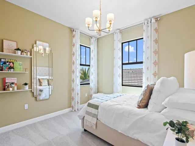 a bedroom with a bed and a chandelier