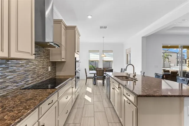 a kitchen with granite countertop a sink and cabinets