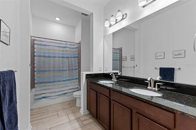 a bathroom with a double vanity sink and a mirror