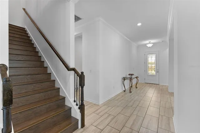 a view of entryway and hall with wooden floor