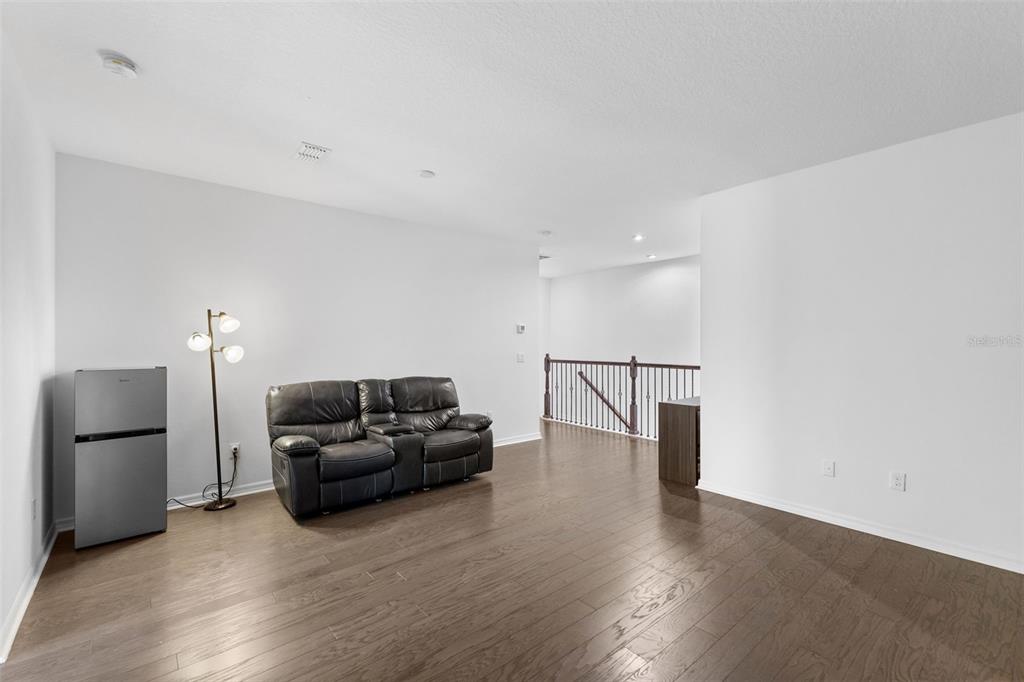 13065 Bliss Loop Bradenton, FL 34211 - Photo 30 of 54 a living room with furniture and a flat screen tv