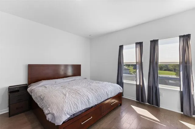 a bedroom with a large bed and a large window