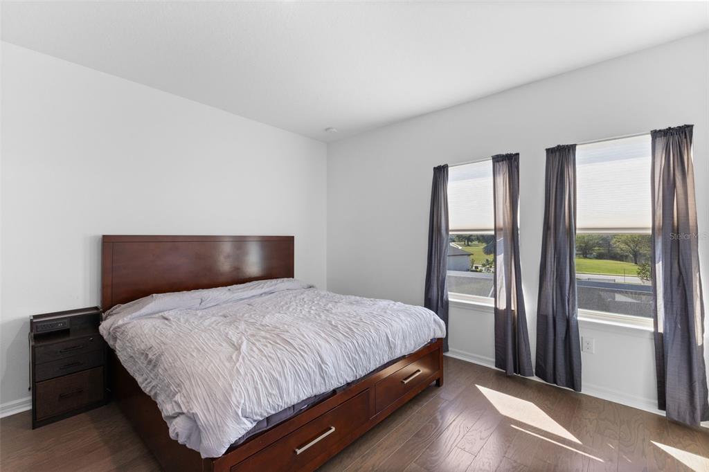 13065 Bliss Loop Bradenton, FL 34211 - Photo 32 of 54 a bedroom with a large bed and a large window