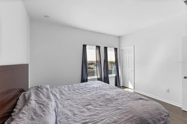 a bedroom with a large bed and a large window