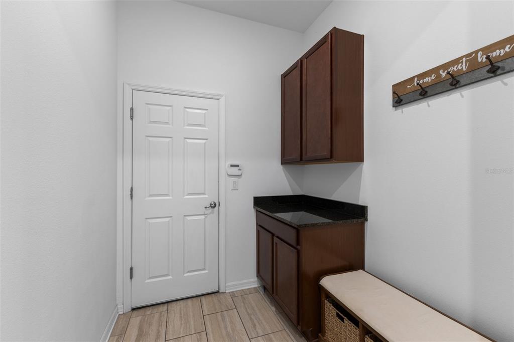 13065 Bliss Loop Bradenton, FL 34211 - Photo 36 of 54 a bathroom with a toilet a sink and wooden floor