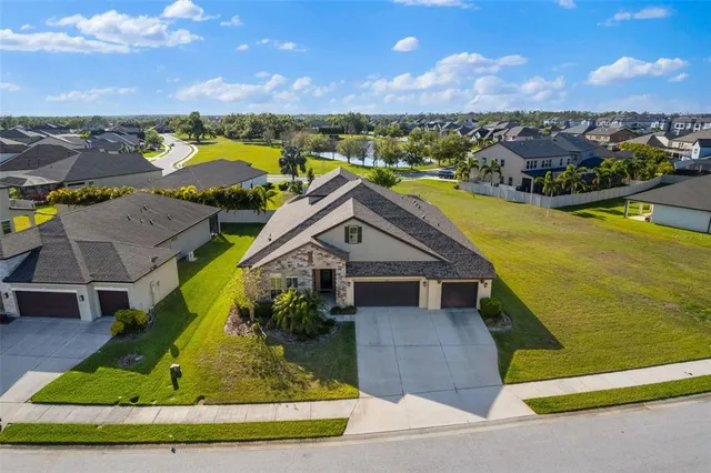 an aerial view of residential houses with outdoor space and swimming pool