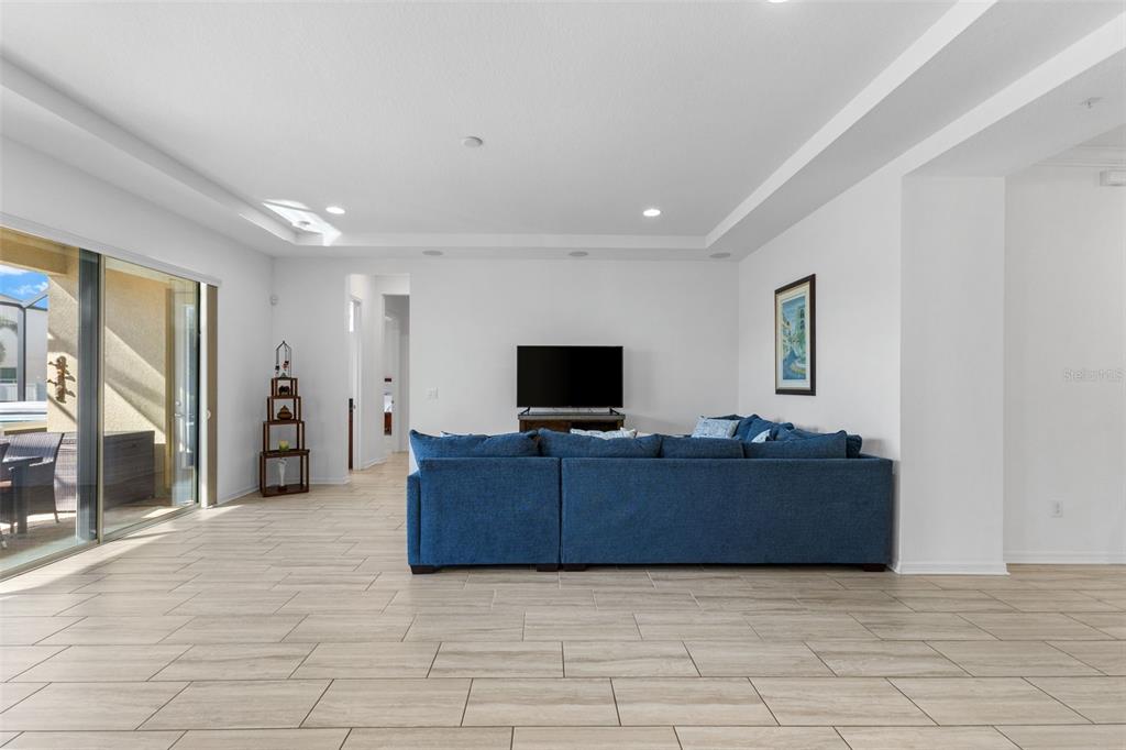 13065 Bliss Loop Bradenton, FL 34211 - Photo 6 of 54 a living room with furniture and a flat screen tv