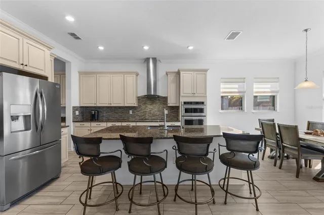 a kitchen with granite countertop white cabinets and stainless steel appliances