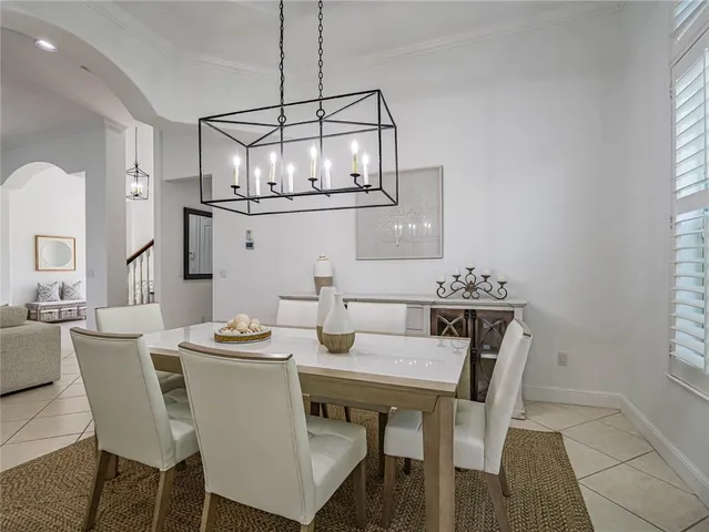 a view of a dining room with furniture and chandelier