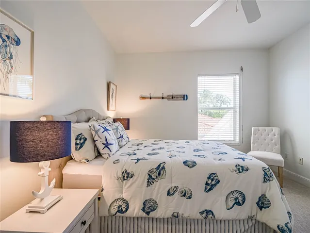 a bedroom with a bed next to a window with a bed