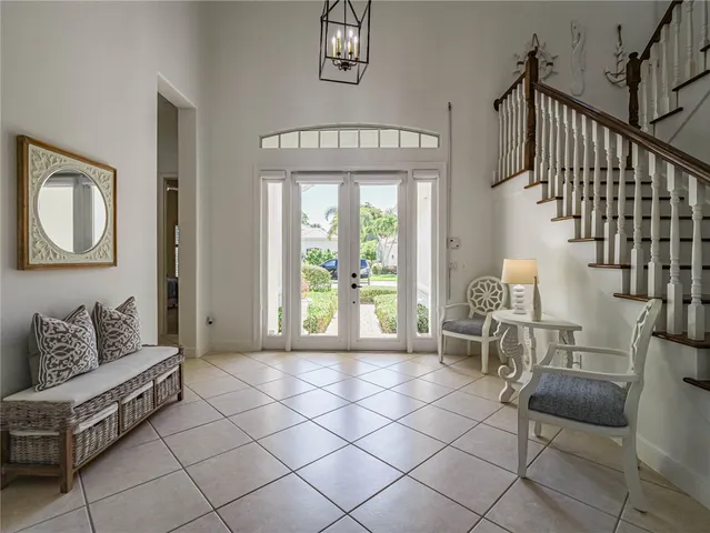 a living room with furniture and a floor to ceiling window