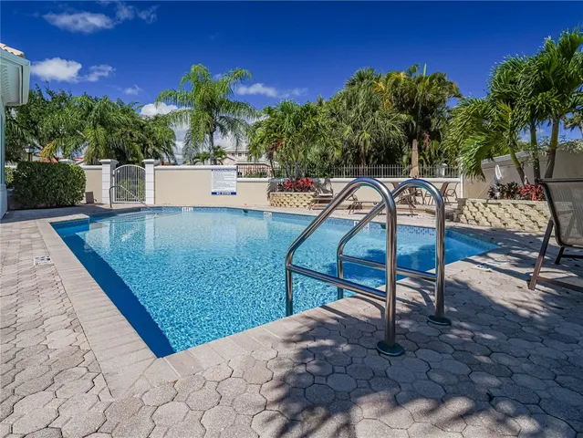an aerial view of a house with swimming pool and outdoor seating